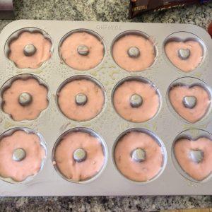Spooning donut batter into pan